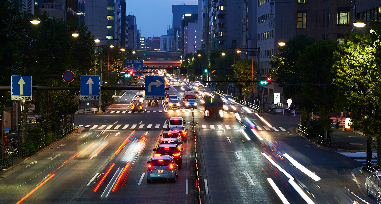 Traffic rushes by at dusk City night scene with headlights streaking by